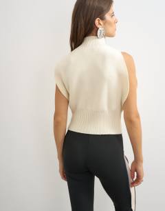 Model wearing Knitted sculpted sleeveless funnel neck jumper in ivory
