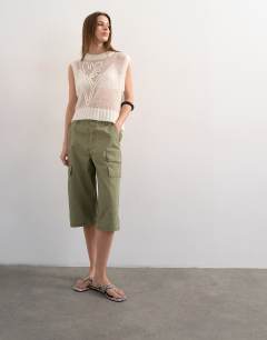 Model wearing Knitted sheer embroidered floral vest in ivory