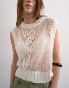 Model wearing Knitted sheer embroidered floral vest in ivory