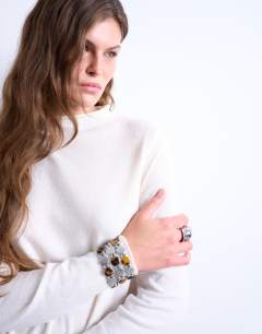 Model wearing Knitted sheer high neck jumper in ivory