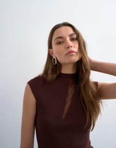 Model wearing Knitted sheer mix cap sleeve top in chocolate