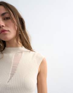 Model wearing Knitted sheer mix cap sleeve top in ivory