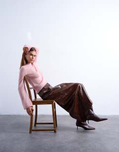 Model wearing Knitted sheer roll neck top in light pink