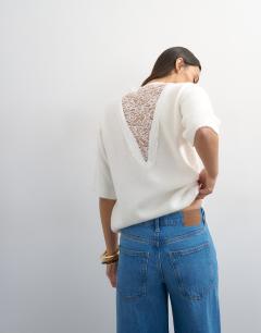 Model wearing Knitted short sleeve lace back detail jumper in ivory