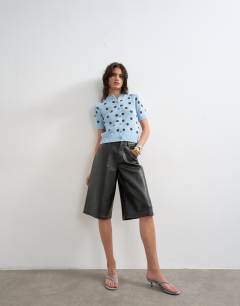 Model wearing Knitted short sleeve polka dot cardigan in blue