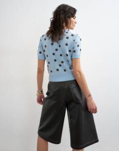 Model wearing Knitted short sleeve polka dot cardigan in blue