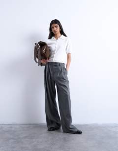 Model wearing Knitted short sleeve polo top in neutral