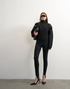 Model wearing Knitted shoulder padded seam detail jacket in black