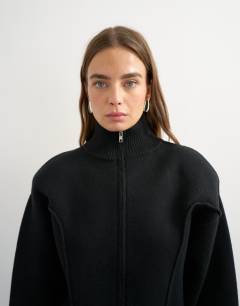 Model wearing Knitted shoulder padded seam detail jacket in black