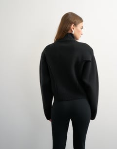 Model wearing Knitted shoulder padded seam detail jacket in black