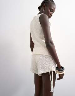 Model wearing Knitted side tie micro co-ord short in ivory