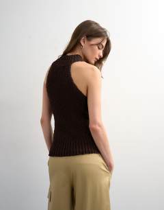 Model wearing Knitted sleeveless textured grown on vest in chocolate