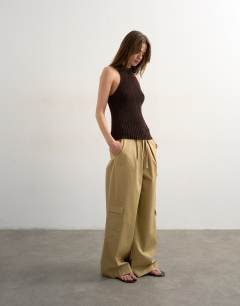 Model wearing Knitted sleeveless textured grown on vest in chocolate