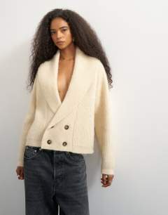 Model wearing Knitted slouchy button front shawl collared cardigan in latte
