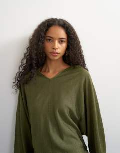 Model wearing Knitted slouchy fine knit batwing sleeve jumper in khaki