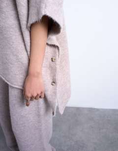 Model wearing Knitted slouchy poncho co-ord in beige