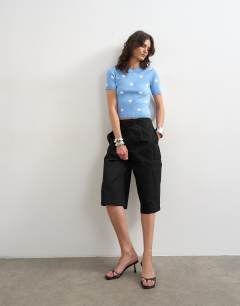 Model wearing Knitted spot high v neck top in blue
