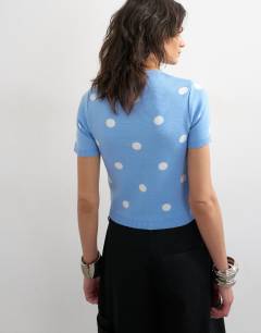 Model wearing Knitted spot high v neck top in blue