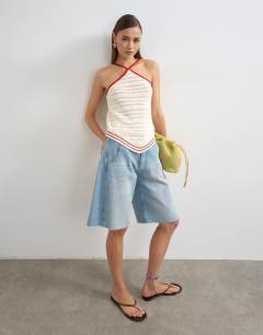 Model wearing Knitted stitchy halter top in ecru and red