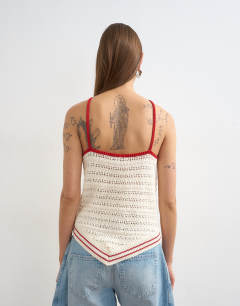 Model wearing Knitted stitchy halter top in ecru and red