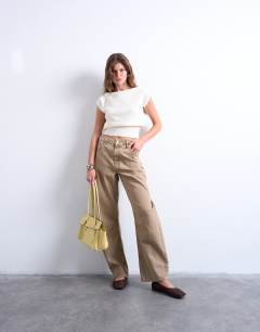 Model wearing Knitted stitchy one shoulder top in cream