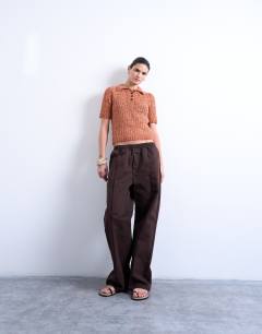 Model wearing Knitted tape yarn polo in rust