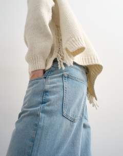 Model wearing Knitted tassel jumper in ivory