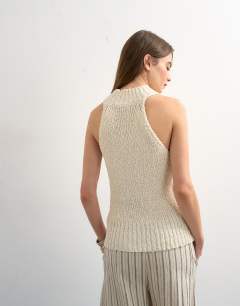 Model wearing Knitted textured grown on vest in ivory