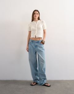 Model wearing Knitted textured short sleeve cardigan in ivory