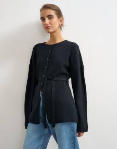 Model wearing Knitted tie back all needle cardigan in navy