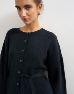 Model wearing Knitted tie back all needle cardigan in navy