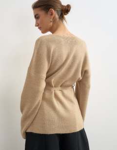 Model wearing Knitted tie back all needle cardigan in oat