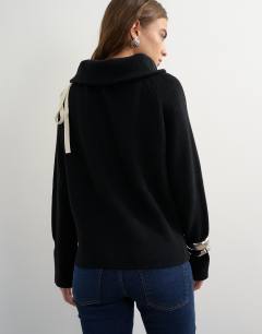 Model wearing Knitted tie funnel neck ribbed jumper in black with ivory tipping