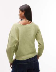 Model wearing Knitted tie neck jumper in green