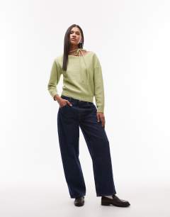 Model wearing Knitted tie neck jumper in green