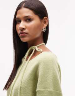 Model wearing Knitted tie neck jumper in green