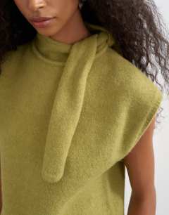 Model wearing Knitted tie neck top in green