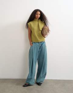 Model wearing Knitted tie neck top in green