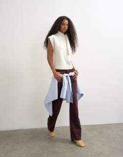 Model wearing Knitted tie neck top in ivory 