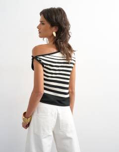 Model wearing Knitted tie shoulder asymmetric top in black and ecru