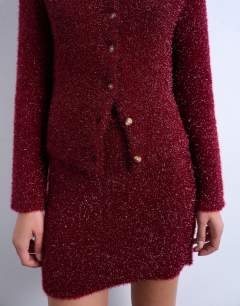 Model wearing Knitted tinsel cardigan in burgundy