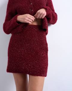 Model wearing Knitted tinsel co-ord skirt in burgundy