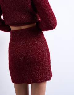 Model wearing Knitted tinsel co-ord skirt in burgundy