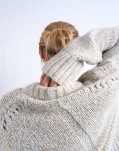 Model wearing Knitted twisted fluffy boxy jumper in blue and yellow