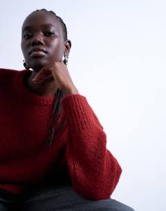 Model wearing Knitted ultimate mid jumper in red
