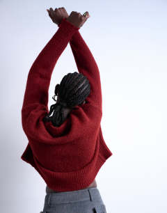Model wearing Knitted ultimate mid jumper in red
