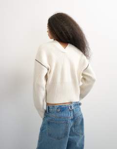 Model wearing Knitted v neck button front cardigan in ivory