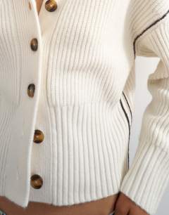 Model wearing Knitted v neck button front cardigan in ivory