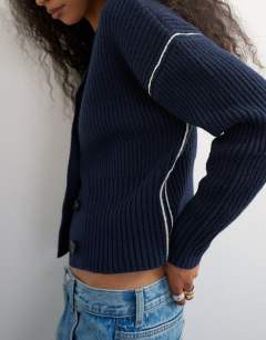 Model wearing Knitted v neck button front cardigan in midnight
