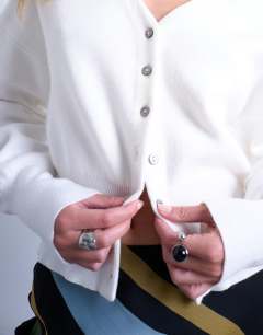 Model wearing Knitted v neck compact fitted waist cardigan in ivory